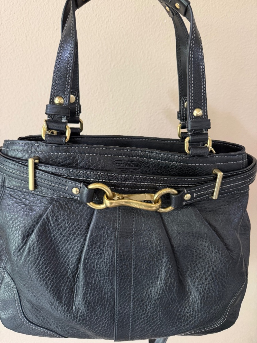 Black Coach shoulder bag with crossbody strap.
